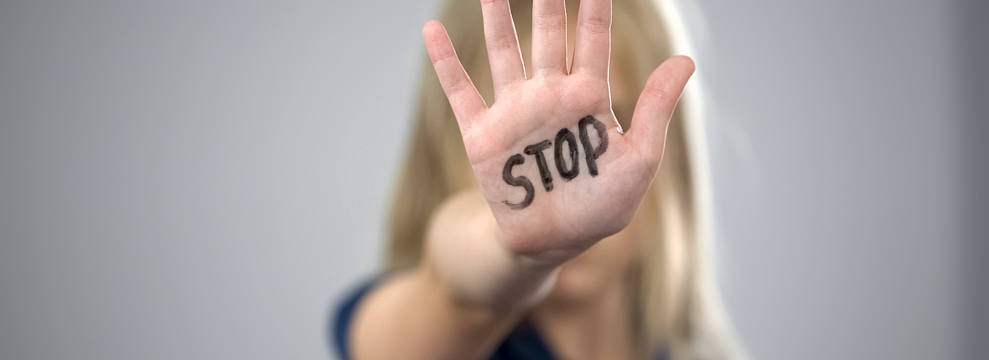 Little girl showing stop sign, child abuse issue, cruelty in family, awareness