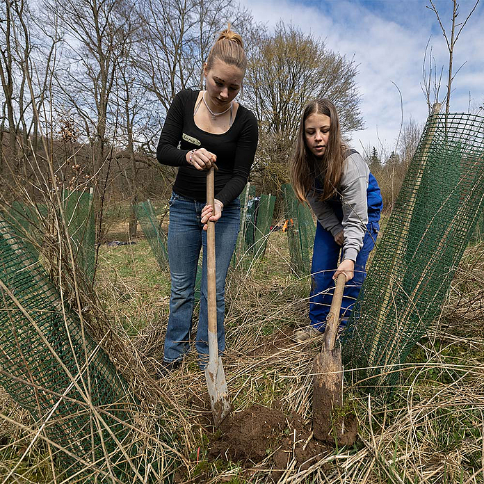 Die Konfirmandinnen Emma und Amelie aus Lohra beim Pflanzen eines Baumes