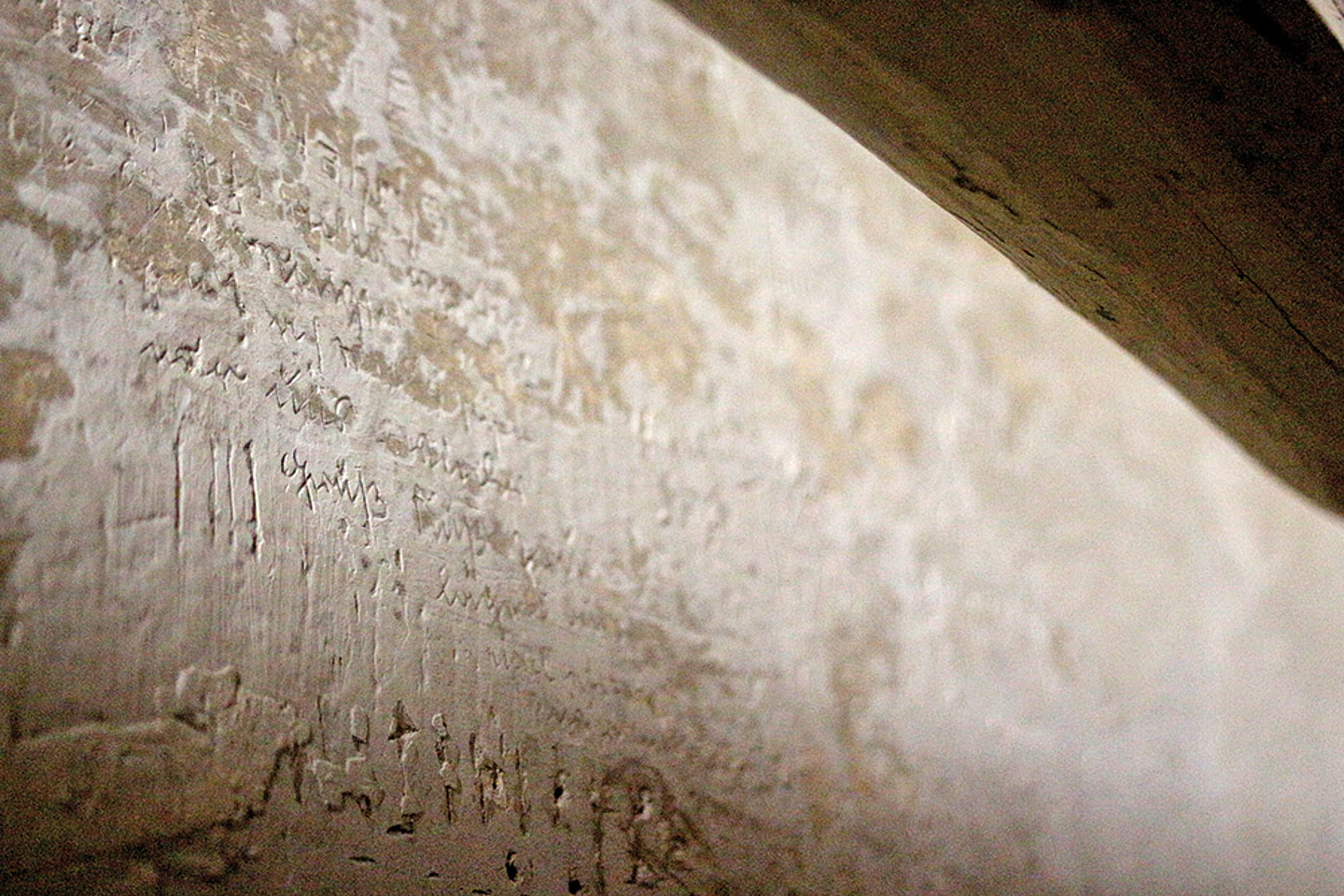 Eine Wand, in die Buchstaben geritzt wurden