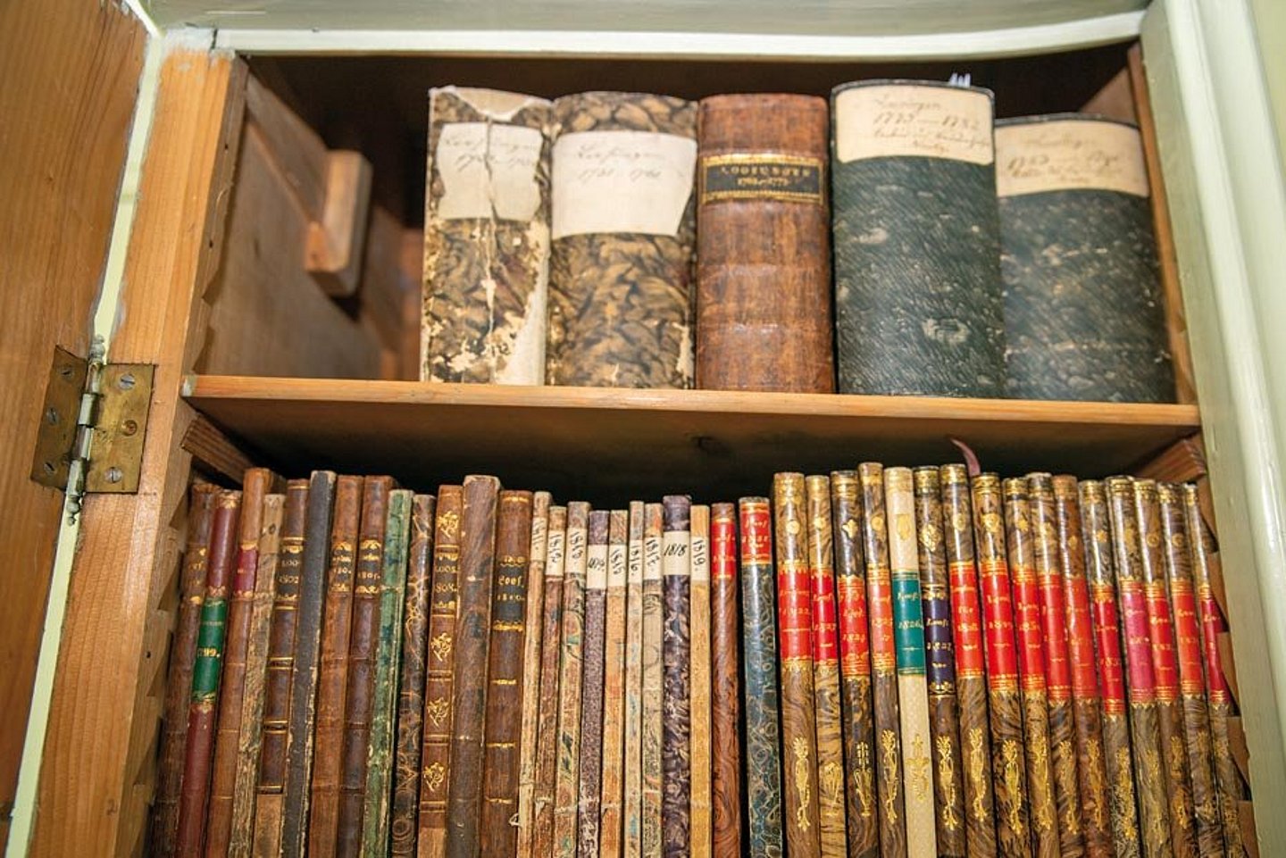 Bücherschrank mit historischen Ausgaben der Losungen.