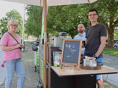 Anlaufpunkt Freizeit- und Skate-Anlage am Melsunger Fulda-Ufer (v.r.): Pfarrer Henning Meinecke und Tobi Jäger mit einer Besucherin der Fahrrad-Kirche.

