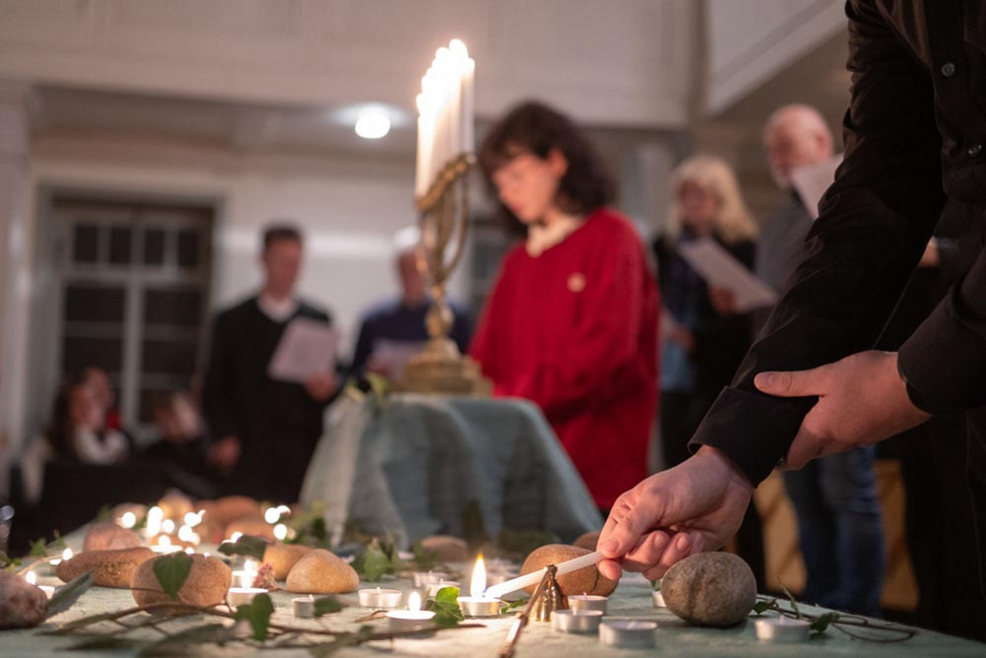 Jugendliche aus der Kirchengemeinde Vöhl entzündeten während des Vorlesens der jüdischen Opfer des Holocaust aus Vöhl 72 Kerzen.