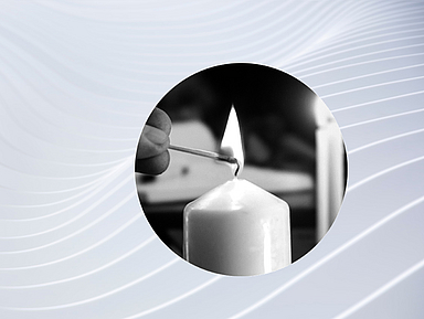 Das Foto zeigt eine brennende Kerze