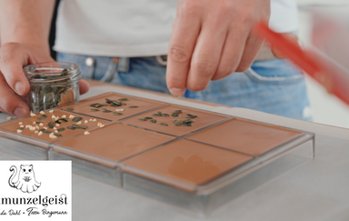 Eine Schokolade wird mit Kürbiskernen dekoriert
