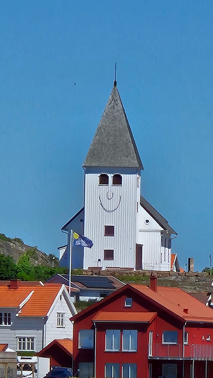 Die Kirche in Skärhamn auf der Insel Tjörn in Südschweden. Auf dem Kirchturm ist um zwei Fenster als Augen ein Gesicht imaginiert. Foto: Sonja Müller