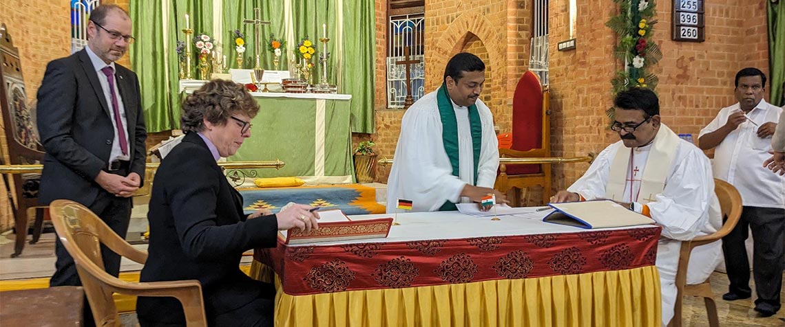 Unterzeichnung im feierlichen Gottesdienst: Bischöfin Dr. Beate Hofmann und Bischof Martin Borgai unterzeichnen den neuen Partnerschaftsvertrag. Links im Bild ist Ökumenedezernent Dr. Diethelm Meißner zu sehen. (Foto: Tümmler)