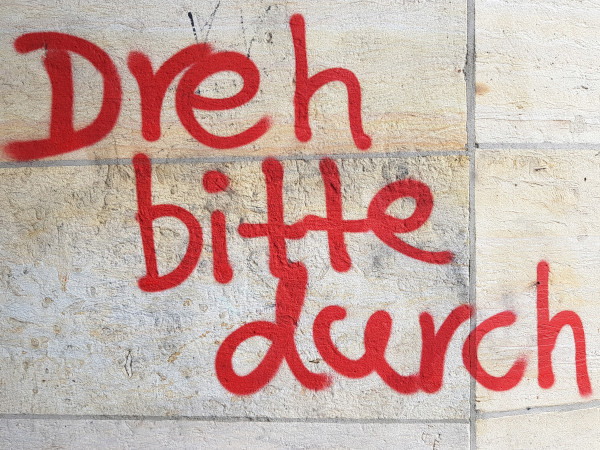 Die Aufforderung "Dreh bitte durch" ist in dicker roter Schrift auf eine Hauswand gesprüht. Foto: Peter Weidemann, pfarrbriefservice.de